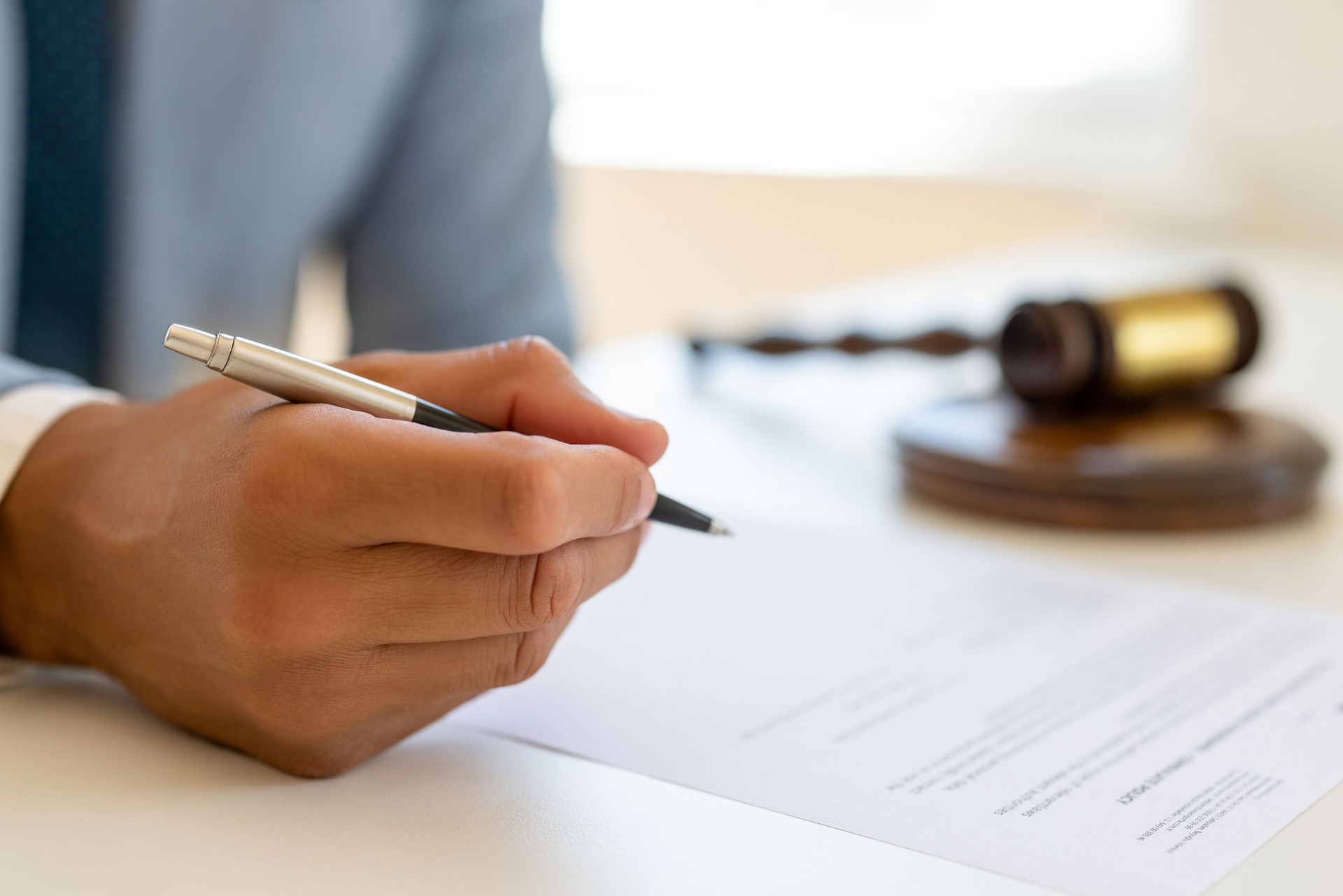 Unrecognisable men filling and signing paper