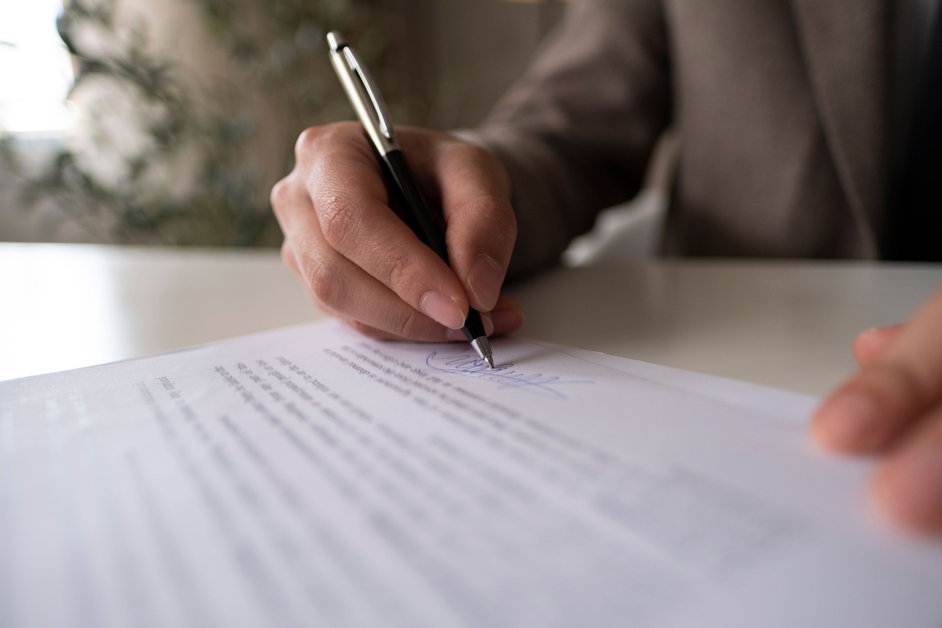 Businessman Signing Contract or Legal Papers